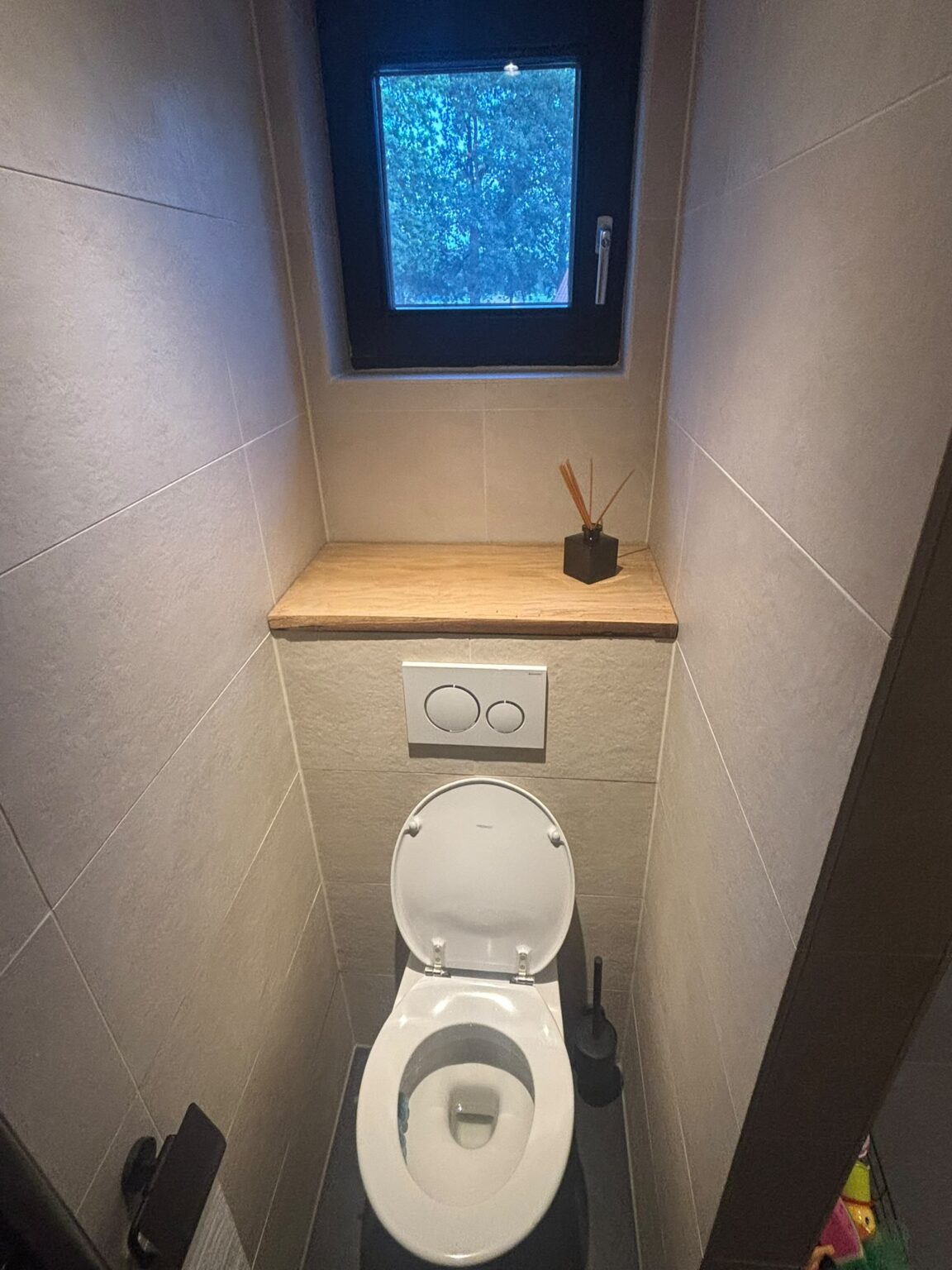 Toilet met inbouwreservoir, houten plank en wandtegels